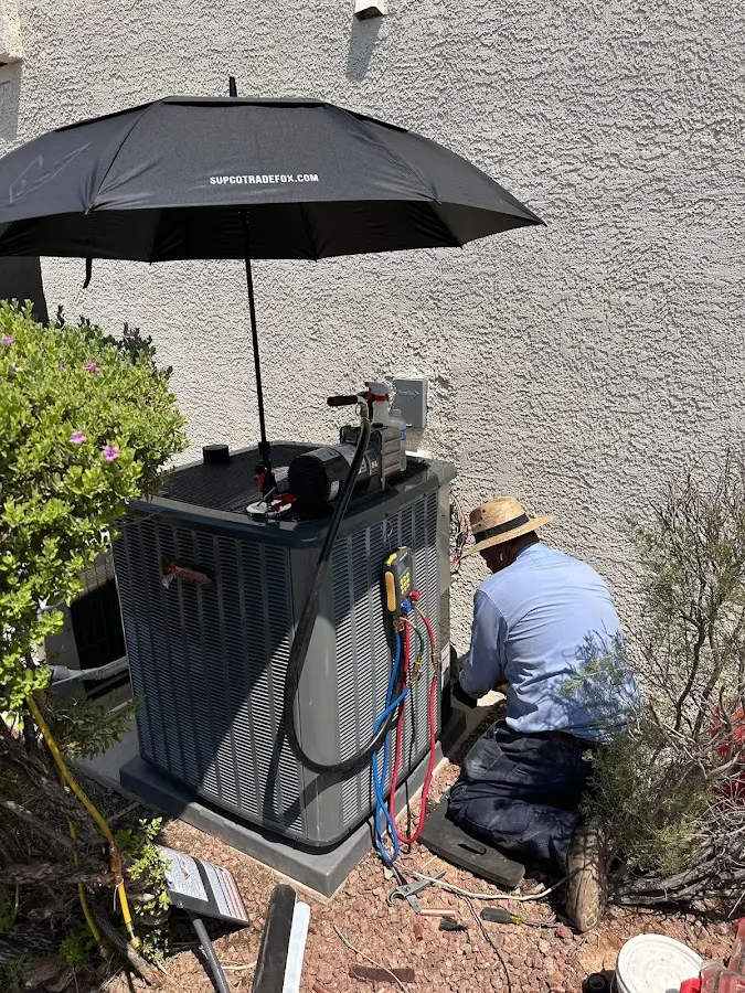 HVAC technician performing outdoor AC maintenance in Laurel