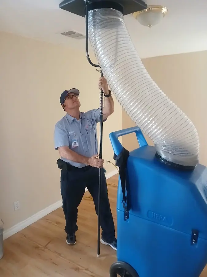 Furnace Tune-Up technician using HEPA equipment in Laurel
